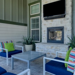 an outdoor seating area with a fireplace