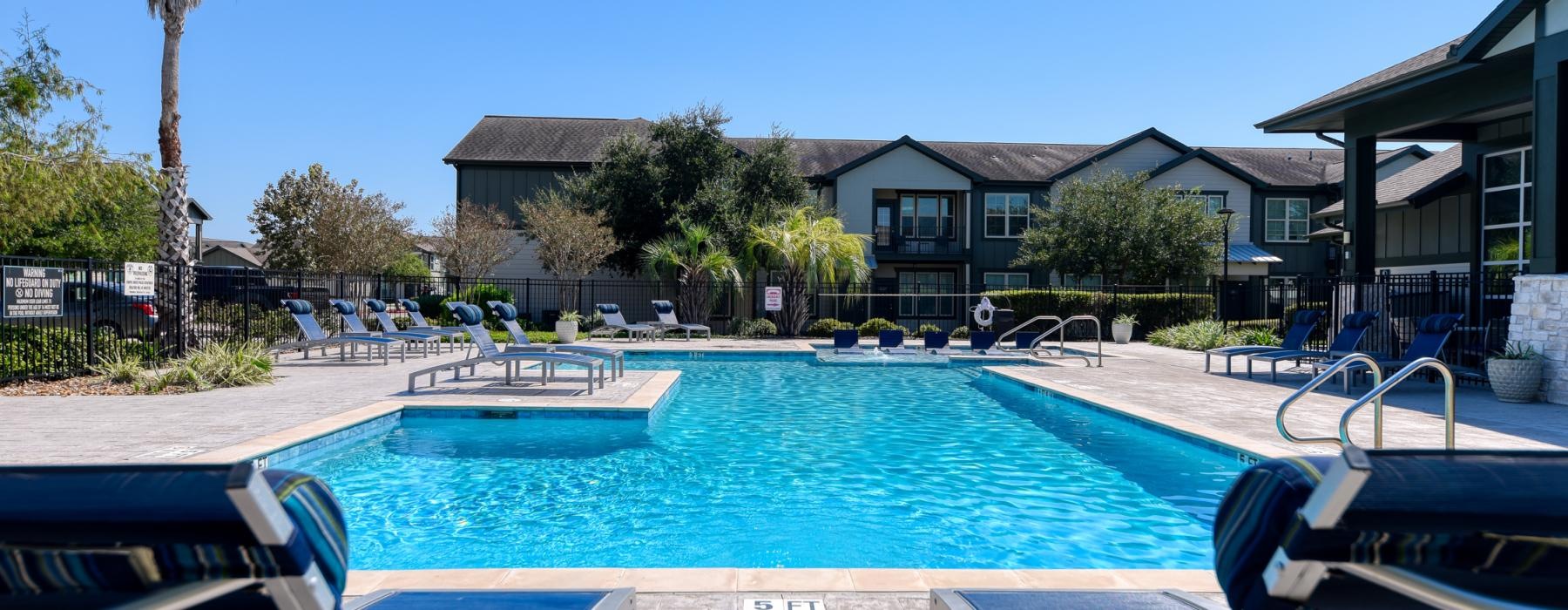 a swimming pool with chairs around it