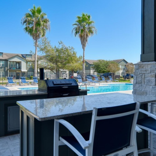 a table and chairs by a grill